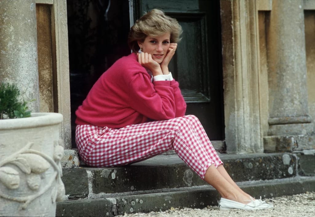 Princess Diana resting her head in her hands whilst sitting on the steps of her home at Highgrove, Gloucestershire.